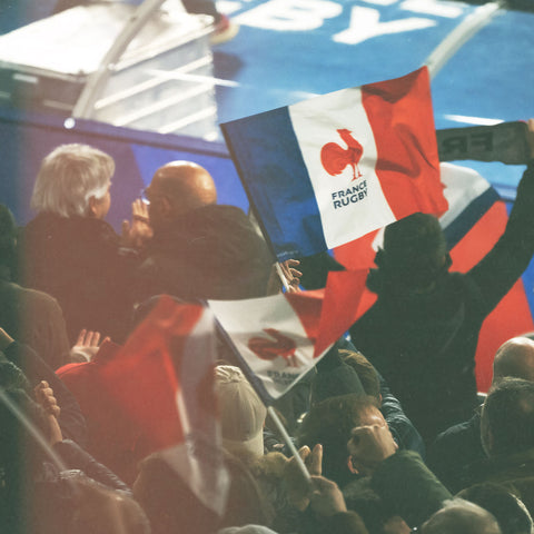 French flag being waved in a rugby crowd